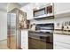 Kitchen area featuring stainless steel refrigerator and microwave above the range at 200 S Dawson St # 103, Raleigh, NC 27601