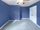 Well-lit bedroom with blue walls, carpeted flooring, and a ceiling fan at 2042 Compacta Dr, Wendell, NC 27591
