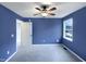 Bedroom with blue walls, carpeted flooring, and a ceiling fan at 2042 Compacta Dr, Wendell, NC 27591