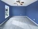 Spacious bedroom with blue walls, carpeted flooring, and a ceiling fan at 2042 Compacta Dr, Wendell, NC 27591