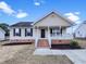 Charming single-story home featuring a cozy front porch and landscaped yard at 2042 Compacta Dr, Wendell, NC 27591