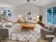 Bright living room with vaulted ceilings, hardwood floors, and large windows at 2042 Compacta Dr, Wendell, NC 27591