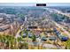 An aerial view shows the home's proximity to Durham, surrounded by mature trees at 210 Monk Rd, Durham, NC 27704