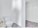 Small toilet room featuring an attached walk-in closet with bright, neutral paint and gray carpet at 210 Monk Rd, Durham, NC 27704