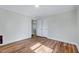 Bedroom with hardwood floors, white walls, closet and entry doorway at 210 Monk Rd, Durham, NC 27704