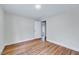 Bright bedroom with hardwood floors and an entry doorway at 210 Monk Rd, Durham, NC 27704