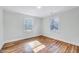 Sun-drenched bedroom with hardwood floors and large windows providing natural light at 210 Monk Rd, Durham, NC 27704