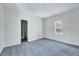 Bright bedroom featuring neutral walls, gray carpet, and a window for ample natural light at 210 Monk Rd, Durham, NC 27704