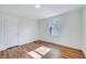 Cozy bedroom with hardwood floors, white walls, and a bright window at 210 Monk Rd, Durham, NC 27704