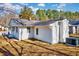 Back exterior view of a white home with a well maintained yard at 210 Monk Rd, Durham, NC 27704