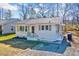 Charming single-story home with white siding, black trim, and well-maintained front yard at 210 Monk Rd, Durham, NC 27704