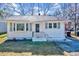 Charming single-story home with white siding, black trim, and well-maintained front yard at 210 Monk Rd, Durham, NC 27704