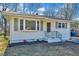 Charming single-story home with white siding, black trim, and well-maintained front yard at 210 Monk Rd, Durham, NC 27704