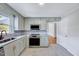 Bright kitchen featuring modern appliances, stylish cabinets, and marble countertops at 210 Monk Rd, Durham, NC 27704