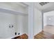 Laundry room with washer/dryer hookups and storage shelves at 210 Monk Rd, Durham, NC 27704