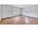 Inviting living room featuring pristine walls, gleaming hardwood flooring, and large window at 210 Monk Rd, Durham, NC 27704