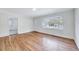 Inviting living room featuring pristine walls, gleaming hardwood flooring, and large window at 210 Monk Rd, Durham, NC 27704