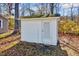 Outside shot of detached shed with white siding and a gray door at 210 Monk Rd, Durham, NC 27704