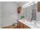 Well-lit bathroom featuring a double sink vanity, wood cabinets, and a neutral color scheme at 232 Eyam Hall Ln, Apex, NC 27502