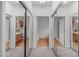 Mirrored doors reflect views into multiple bathrooms, each with vanities at 232 Eyam Hall Ln, Apex, NC 27502