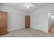 Bright bedroom with a window, ceiling fan, carpet, and wooden armoire at 232 Eyam Hall Ln, Apex, NC 27502