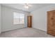 Neutral bedroom featuring a window, ceiling fan, carpet, and a built-in armoire at 232 Eyam Hall Ln, Apex, NC 27502