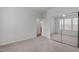 Bright bedroom with carpet, a sliding closet, and a glimpse into the en-suite bath at 232 Eyam Hall Ln, Apex, NC 27502