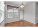 Dining area with natural light, hardwood floors, and a chandelier, offering a cozy and inviting space at 232 Eyam Hall Ln, Apex, NC 27502
