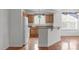 Bright kitchen with hardwood floors and wooden cabinets, offering a blend of functionality and style at 232 Eyam Hall Ln, Apex, NC 27502
