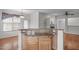 Kitchen island featuring granite countertops and oak cabinets; open to another room at 232 Eyam Hall Ln, Apex, NC 27502