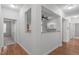 Open living space with hardwood floors and views into the kitchen and dining area at 232 Eyam Hall Ln, Apex, NC 27502