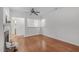 Open-concept living area featuring hardwood floors, a fireplace, and open access to other rooms at 232 Eyam Hall Ln, Apex, NC 27502