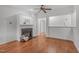 Cozy living room with fireplace, hardwood floors, and open entryways, creating a warm and inviting space at 232 Eyam Hall Ln, Apex, NC 27502