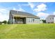 Spacious backyard with covered patio, lush green lawn, and a charming exterior view at 26 Kitty Branch Way, Smithfield, NC 27577