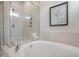 Bright bathroom features a soaking tub, glass-enclosed shower, and neutral tile at 26 Kitty Branch Way, Smithfield, NC 27577