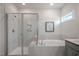 Bright bathroom showcasing a glass-enclosed shower, soaking tub, and modern fixtures for a luxurious experience at 26 Kitty Branch Way, Smithfield, NC 27577