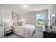 A sunlit bedroom with a light-colored bed and coordinated decor at 26 Kitty Branch Way, Smithfield, NC 27577