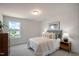 Bright bedroom featuring a plush bed, side tables, and a large window at 26 Kitty Branch Way, Smithfield, NC 27577