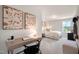Bright bedroom with desk and abstract art, features a neutral color scheme and natural light at 26 Kitty Branch Way, Smithfield, NC 27577