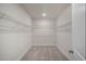 Spacious walk-in closet with wire shelving and carpet flooring at 26 Kitty Branch Way, Smithfield, NC 27577
