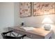 Bright desk with lamp and abstract art in neutral colors with a view into the bedroom at 26 Kitty Branch Way, Smithfield, NC 27577