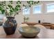 Close up on a rustic dining table with modern chairs and decor in a sunlit room at 26 Kitty Branch Way, Smithfield, NC 27577