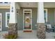 Charming front entrance with stone pillars and 'New Home' welcome mat at 26 Kitty Branch Way, Smithfield, NC 27577