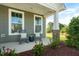 Inviting front porch with rocking chairs and stone pillar accents at 26 Kitty Branch Way, Smithfield, NC 27577