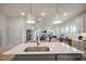 Open concept kitchen with large island, modern lighting, and access to the living area at 26 Kitty Branch Way, Smithfield, NC 27577