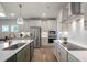 Stylish kitchen with stainless steel appliances, white cabinets, and herringbone backsplash at 26 Kitty Branch Way, Smithfield, NC 27577