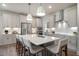 This kitchen has an island with seating, stainless steel appliances and pendant lighting at 26 Kitty Branch Way, Smithfield, NC 27577