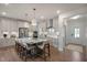 This bright, open kitchen features an island with seating, stainless steel appliances, and a white backsplash at 26 Kitty Branch Way, Smithfield, NC 27577