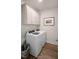 Convenient laundry room with washer, dryer, cabinetry, and wood-look floors at 26 Kitty Branch Way, Smithfield, NC 27577