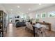 Bright, open-concept living area with fireplace, modern furniture, and wood-look flooring at 26 Kitty Branch Way, Smithfield, NC 27577